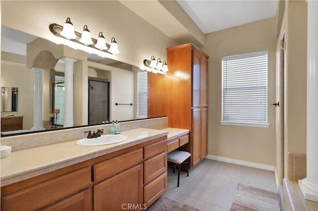 bathroom with decorative columns, vanity, tile patterned flooring, and an enclosed shower