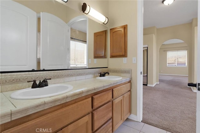 bathroom with vanity, tile patterned floors, and backsplash