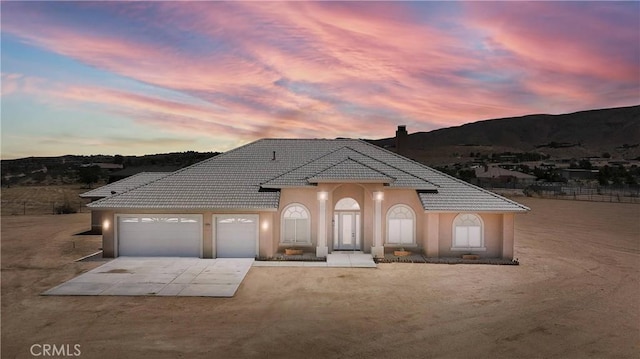 view of front of home featuring a garage and a mountain view