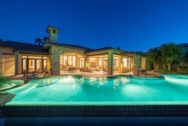 pool at night with a patio