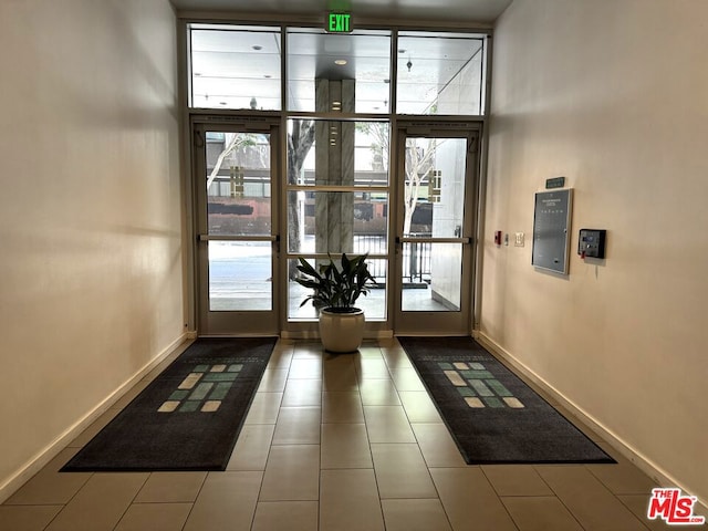 doorway to outside featuring tile patterned flooring