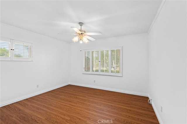 unfurnished room with crown molding, plenty of natural light, ceiling fan, and hardwood / wood-style floors