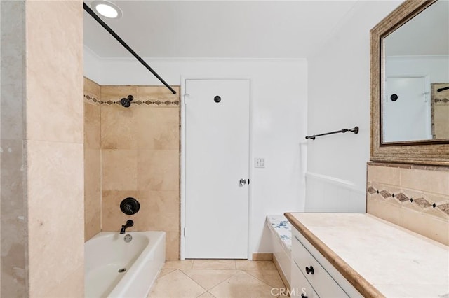 bathroom with crown molding, tile patterned flooring, vanity, and tiled shower / bath combo