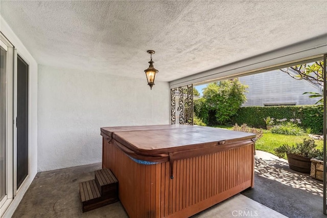 view of patio / terrace with a hot tub