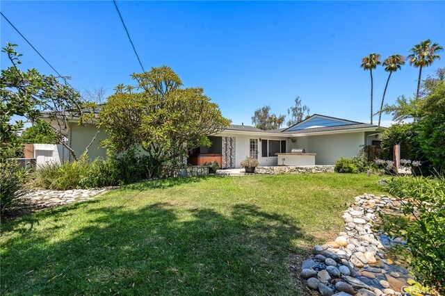 rear view of house with a yard