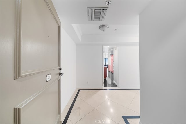 hall featuring light tile patterned floors