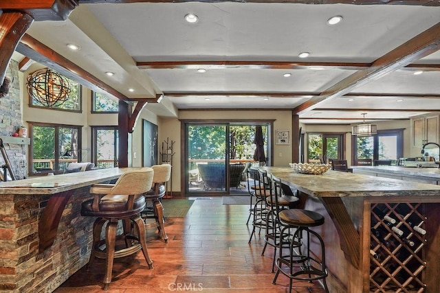 29130 Bald Eagle Rdg, Lake Arrowhead, CA 92352 - kitchen featuring a kitchen breakfast bar, light stone counters, dark wood-type flooring, beam ceiling, and hanging light fixtures