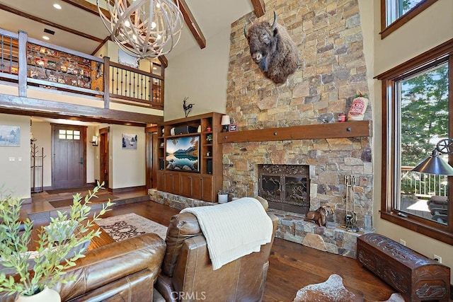 29130 Bald Eagle Rdg, Lake Arrowhead, CA 92352 - living room featuring high vaulted ceiling, an inviting chandelier, a stone fireplace, beamed ceiling, and dark hardwood / wood-style flooring