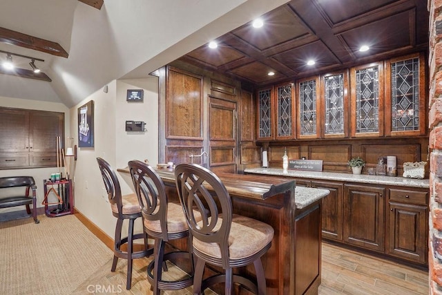 29130 Bald Eagle Rdg, Lake Arrowhead, CA 92352 - bar featuring dark brown cabinetry, light stone counters, light hardwood / wood-style floors, and coffered ceiling