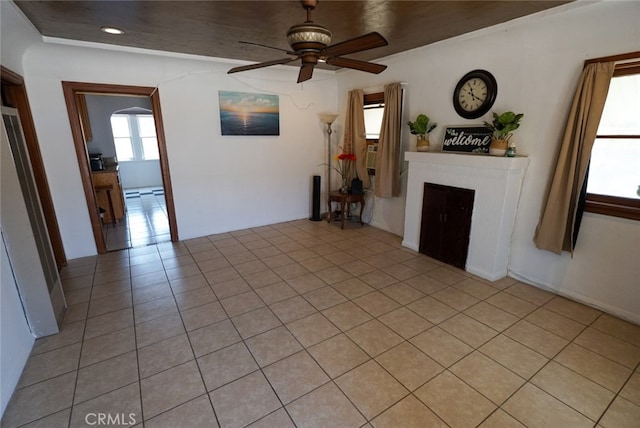 unfurnished living room featuring light tile patterned floors and ceiling fan