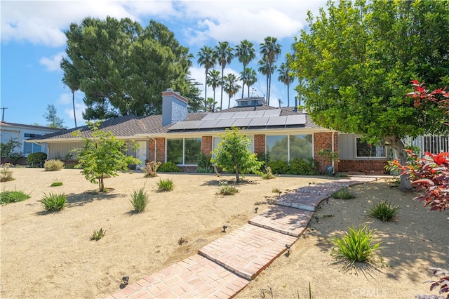 back of house with solar panels