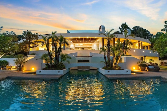 view of pool at dusk