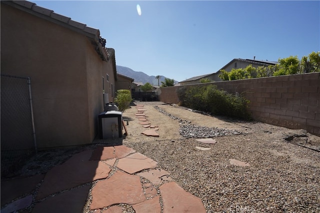 view of yard featuring a fenced backyard and a mountain view