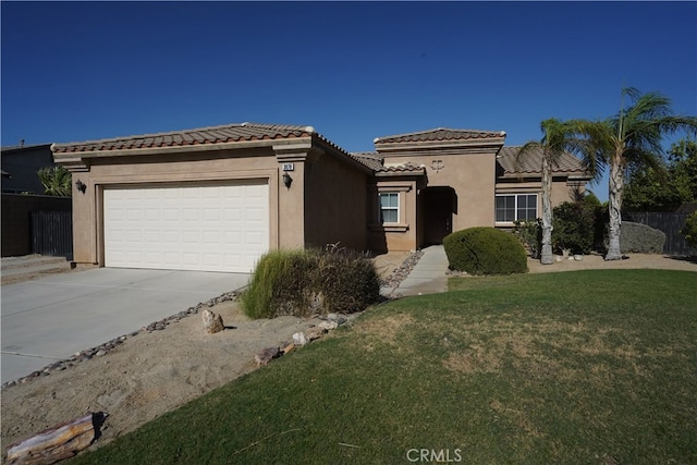 view of front of home featuring a front yard and a garage