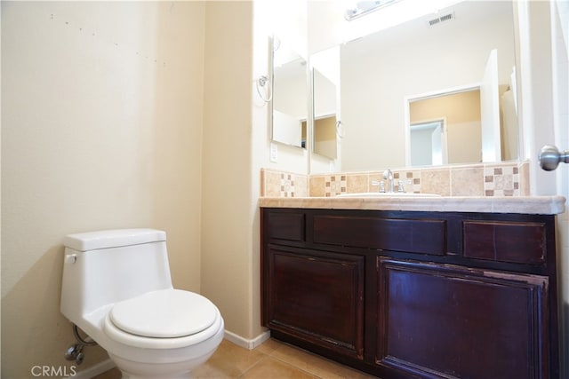 bathroom featuring visible vents, toilet, tile patterned flooring, vanity, and backsplash