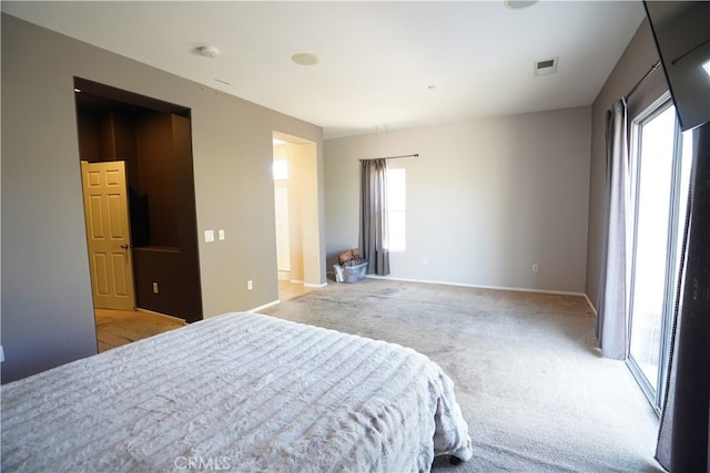 bedroom with light carpet, baseboards, and visible vents