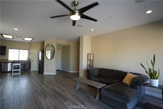 living area with dark wood-style flooring, visible vents, and baseboards