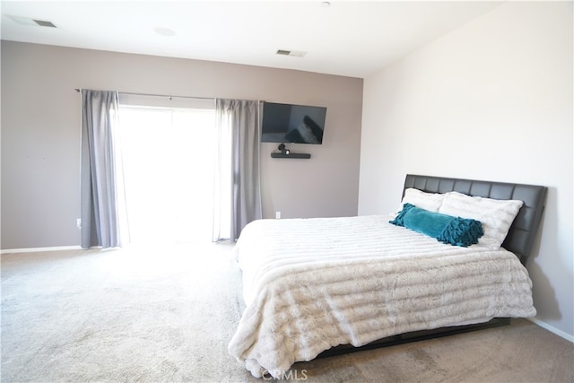 carpeted bedroom featuring visible vents and baseboards