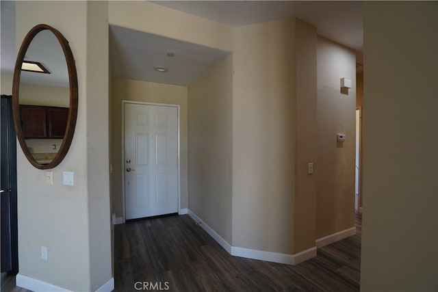 hall featuring dark wood-style floors and baseboards