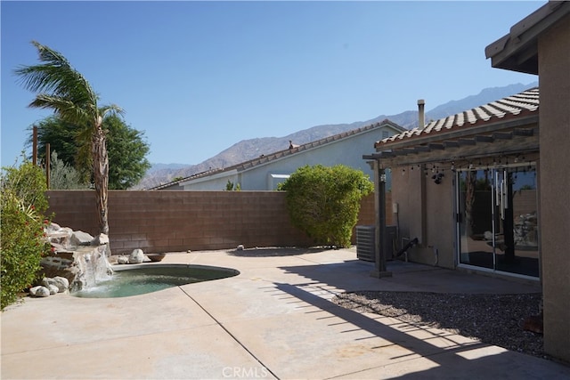 view of patio with a fenced backyard and a mountain view