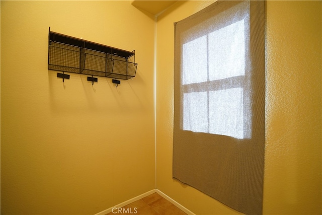 mudroom with tile patterned floors and baseboards