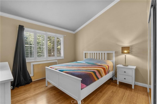 bedroom featuring light hardwood / wood-style floors and ornamental molding