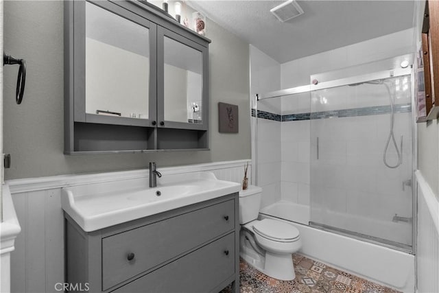 full bathroom with vanity, toilet, and shower / bath combination with glass door