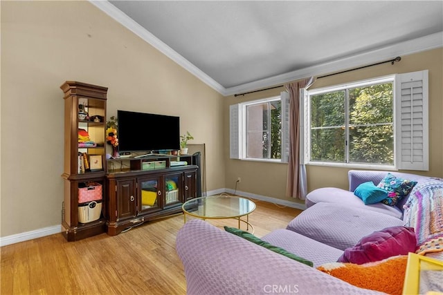 living room with light hardwood / wood-style floors, ornamental molding, and vaulted ceiling