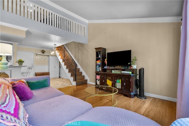 living room with crown molding and hardwood / wood-style floors