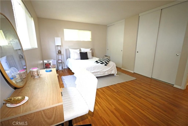 622 E Lomita Ave, Orange, CA 92867 - bedroom featuring wood finished floors, two closets, and multiple windows