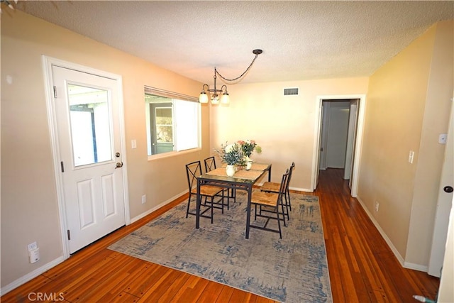 622 E Lomita Ave, Orange, CA 92867 - dining area with an inviting chandelier, wood finished floors, visible vents, and a textured ceiling