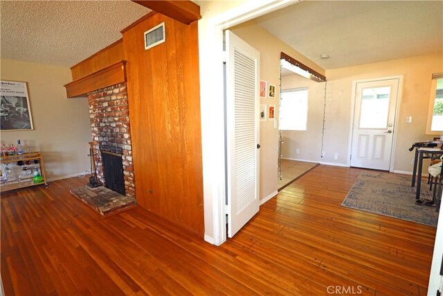 622 E Lomita Ave, Orange, CA 92867 - corridor with hardwood / wood-style flooring, baseboards, a textured ceiling, and visible vents