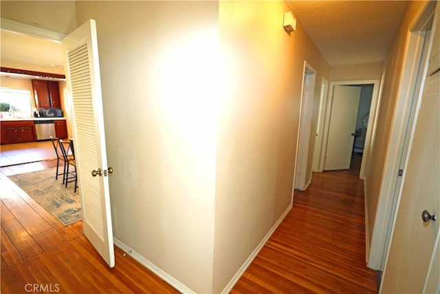 622 E Lomita Ave, Orange, CA 92867 - corridor with baseboards, a sink, and light wood-style floors