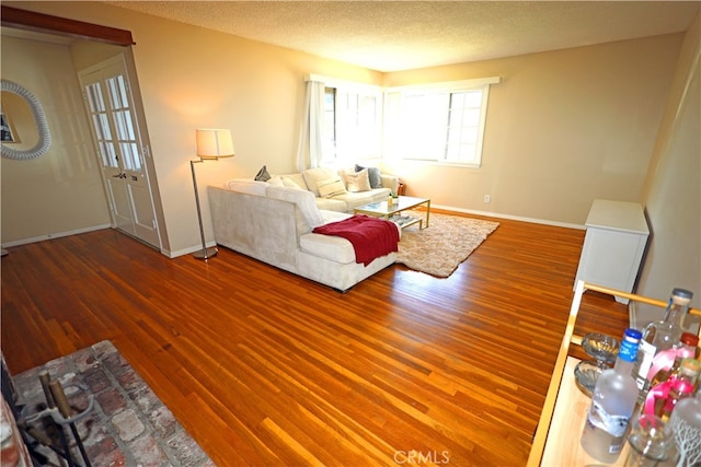 living room featuring a textured ceiling and hardwood / wood-style flooring