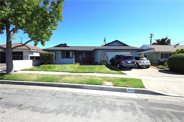 single story home with a front yard and a garage