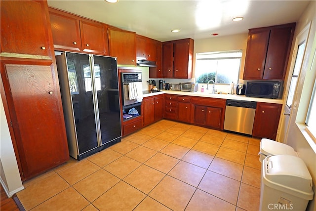 kitchen with sink, extractor fan, black appliances, and light tile patterned floors