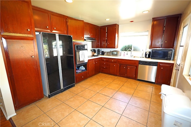 kitchen featuring light tile patterned flooring, black appliances, and sink