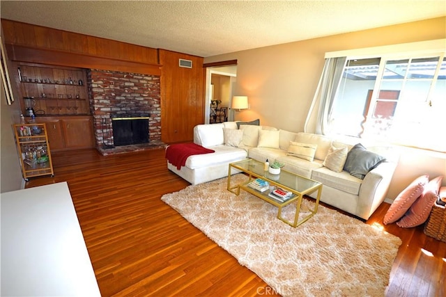 622 E Lomita Ave, Orange, CA 92867 - living room with wood finished floors, visible vents, and a fireplace
