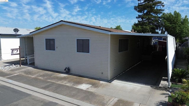 view of property exterior featuring a carport