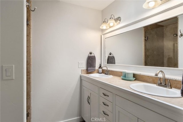 full bath with double vanity, a tile shower, and a sink