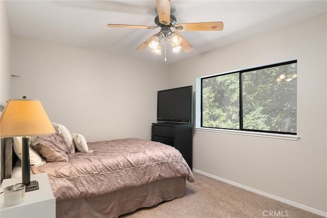 carpeted bedroom with baseboards and ceiling fan