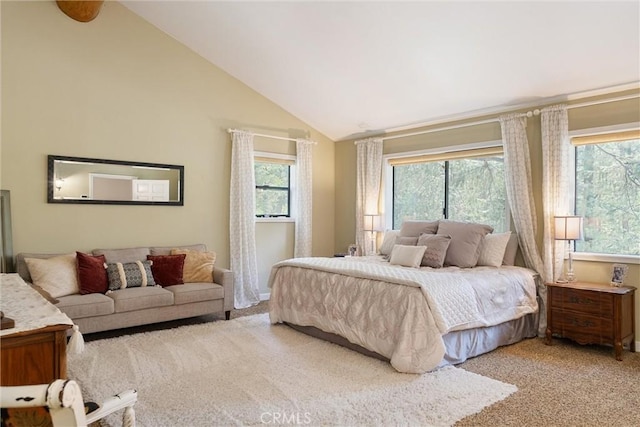 carpeted bedroom featuring high vaulted ceiling