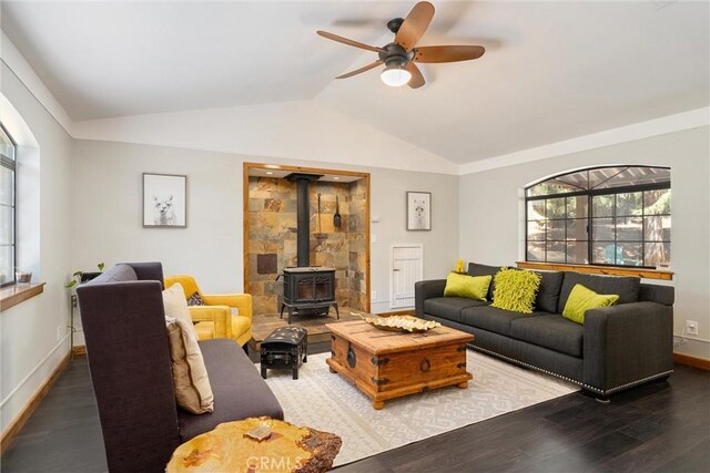 living room with a wood stove, ceiling fan, dark hardwood / wood-style floors, and lofted ceiling