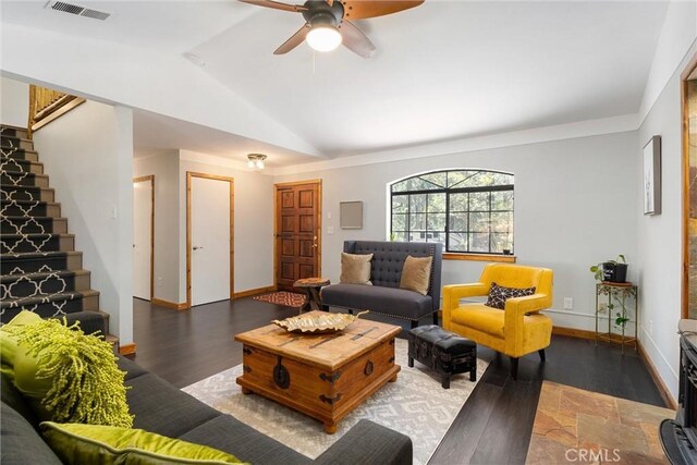 living room featuring vaulted ceiling, ceiling fan, and dark wood-type flooring