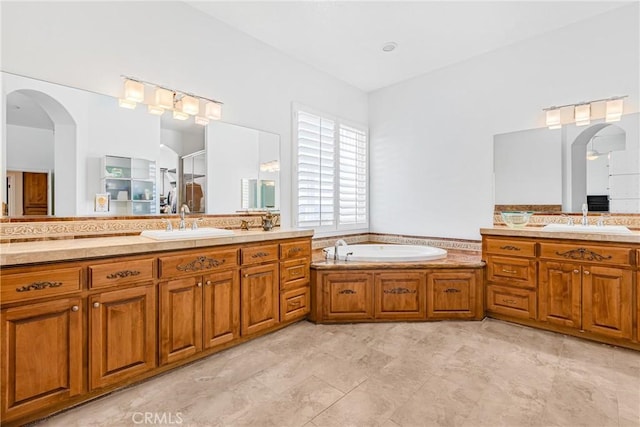 bathroom with a washtub and vanity