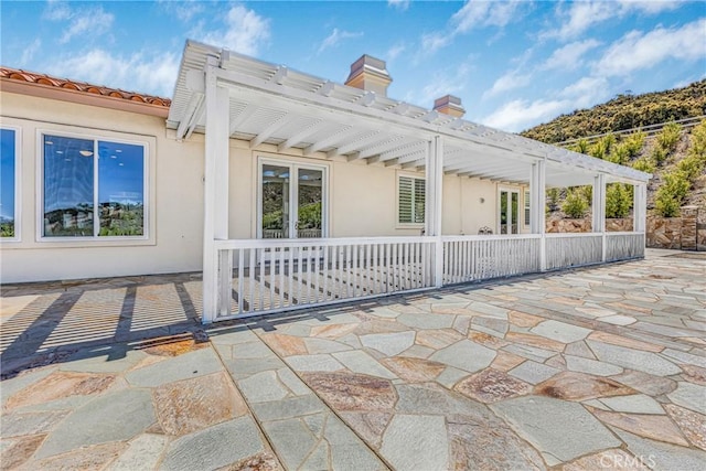 view of side of home with a patio area and a pergola