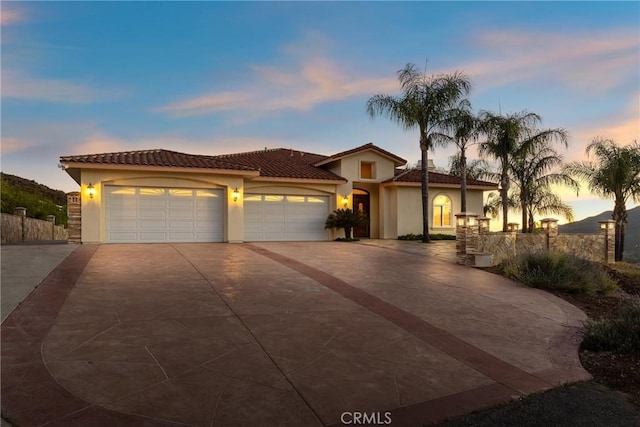 mediterranean / spanish-style house with a garage