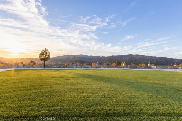 view of community with a water and mountain view and a lawn