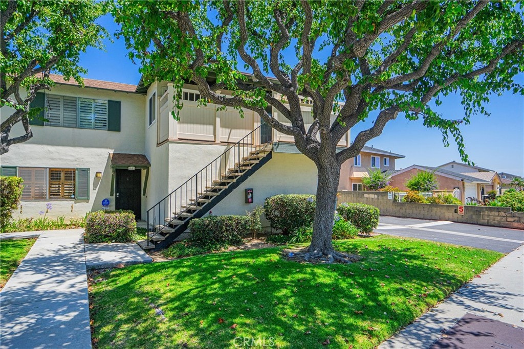 view of front of home with a garage and a front lawn