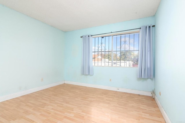 spare room with light wood-type flooring